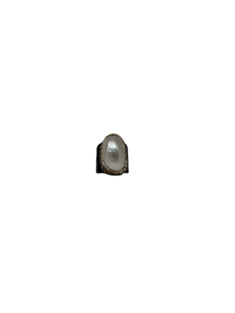 Fashion gemstone ring featuring a large oval white pearl center surrounded by small crystals.