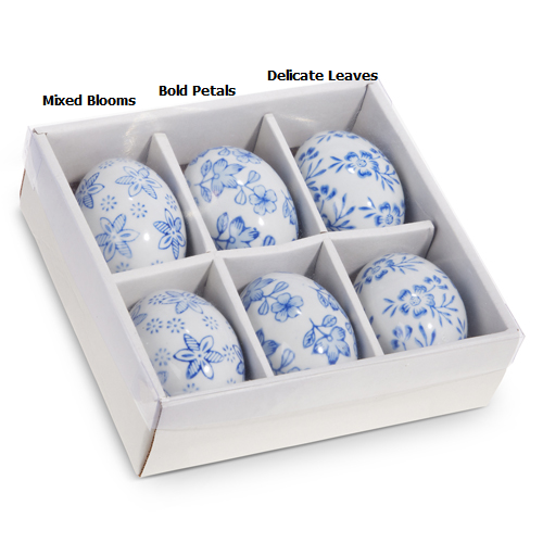 Porcelain egg with blue floral pattern on white background