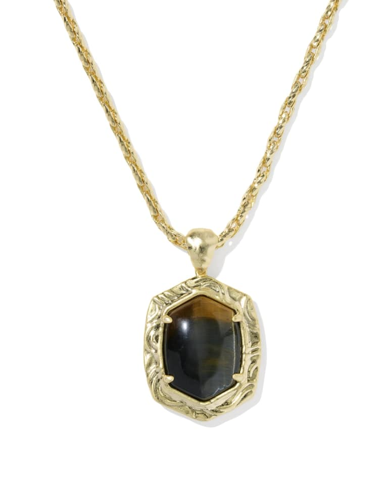 Gold long pendant necklace with a tiger striped stone in a textured hexagonal frame.