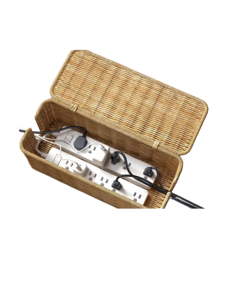 Open rectangular woven rattan cable box concealing two white power strips and various cords.