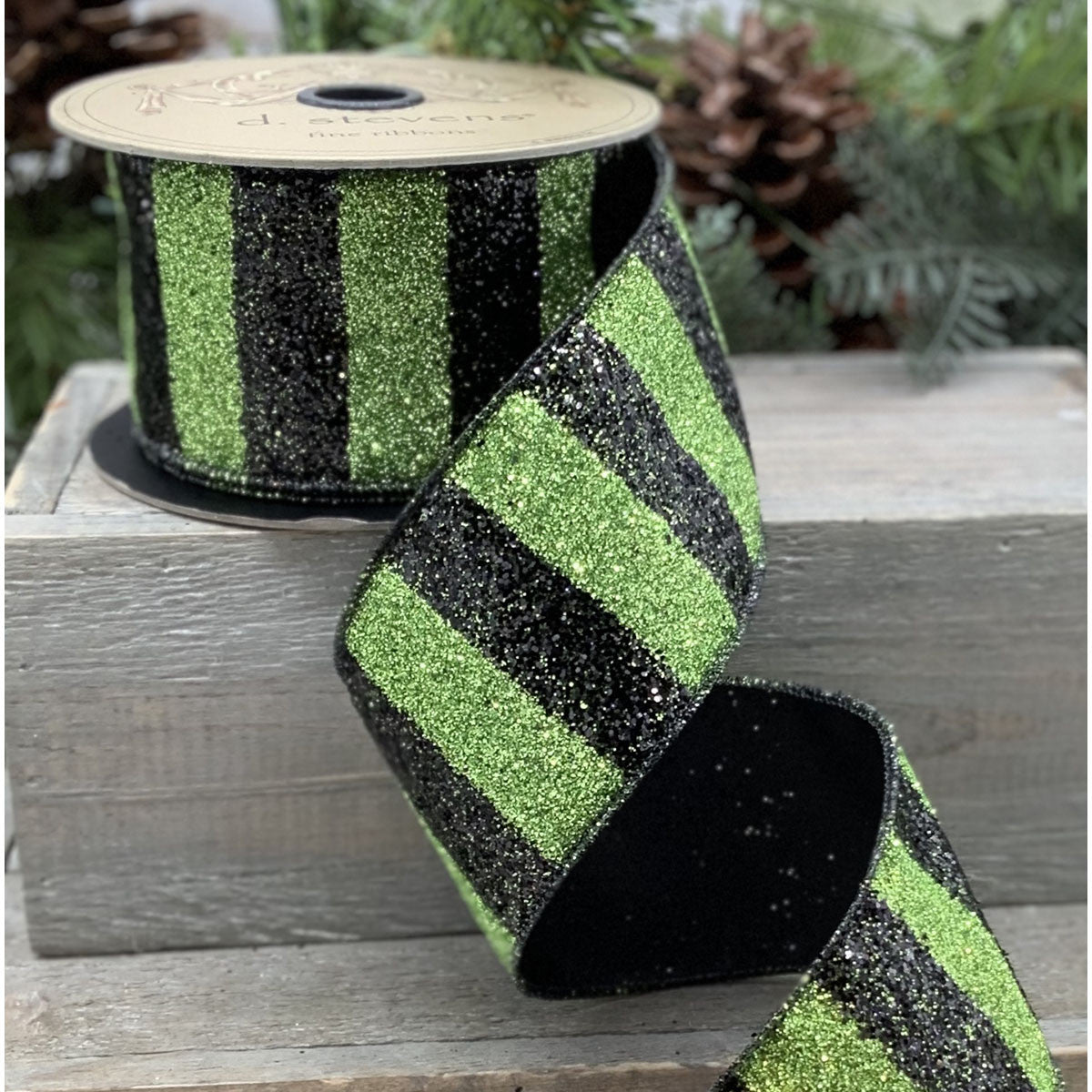 Black ribbon with green glitter stripes measuring 2.5 inches wide.