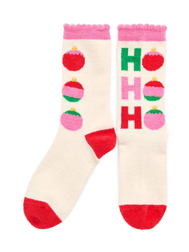 Ivory fuzzy socks with red heels and toes, featuring pink and red ornaments and 'Ho Ho Ho' text.