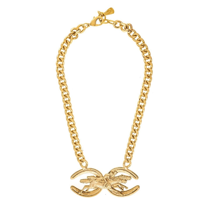 Gold curb-link necklace featuring a centerpiece of a galloping horse between two crescent shapes.