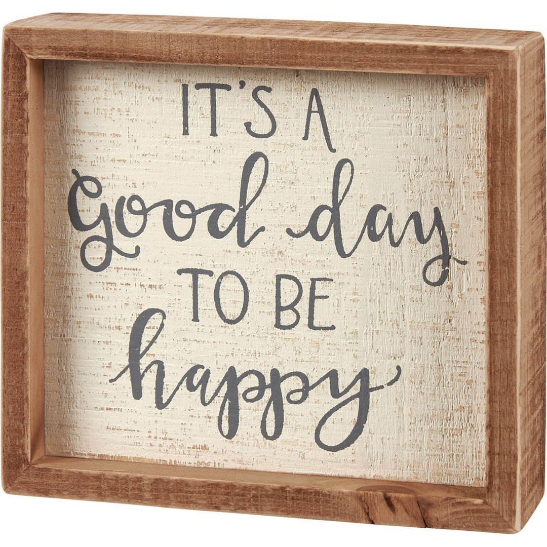 Wooden inset box sign with text reading 'It's A Good Day To Be Happy' in a simple font.