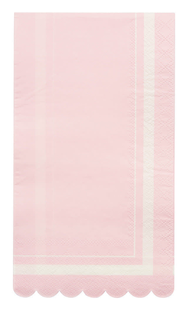 Folded blush scalloped-edge guest towel made from sustainable compostable paper.