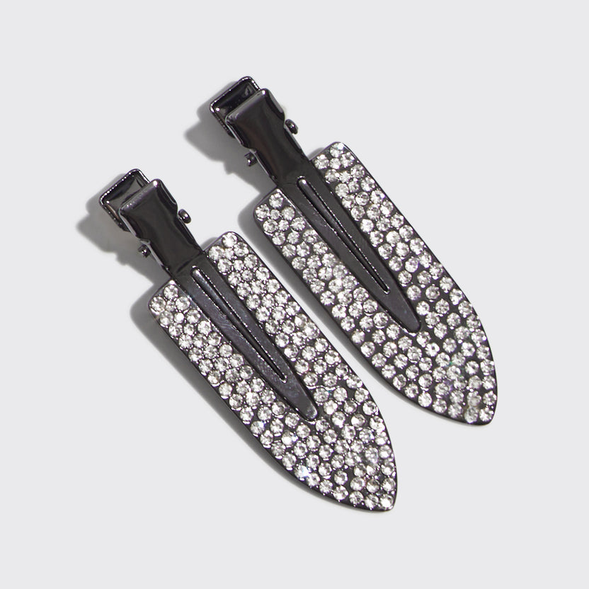 Two gunmetal grey metal creaseless hair clips embellished with clear rhinestones.
