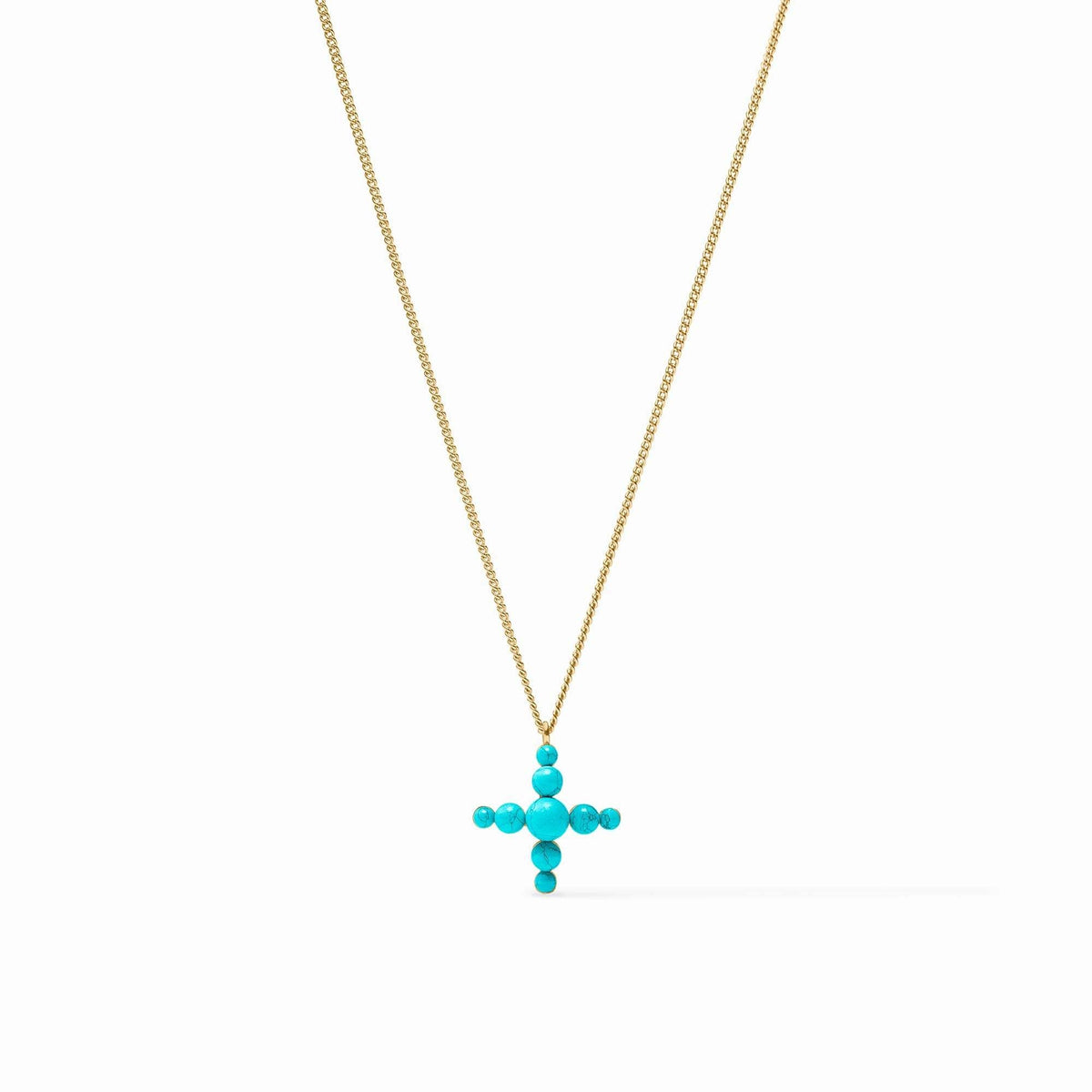 Turquoise blue reconstituted stone cross pendant on a delicate gold curb chain necklace.