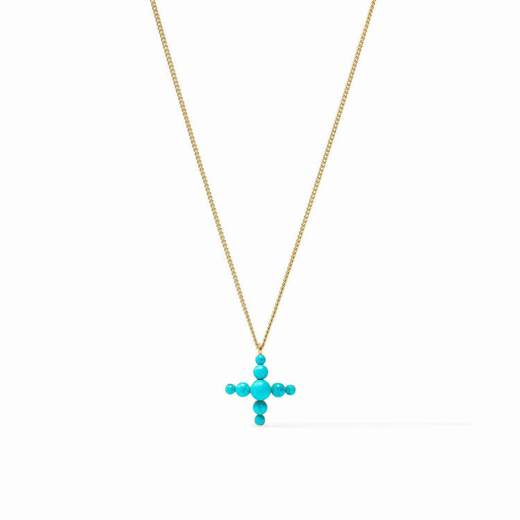 Turquoise blue reconstituted stone cross pendant on a delicate gold curb chain necklace.
