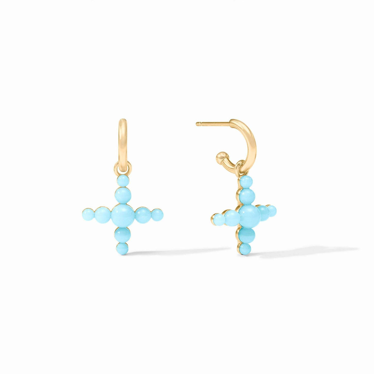 Powder blue reconstituted stone cross charm dangling from gold huggie hoop earring