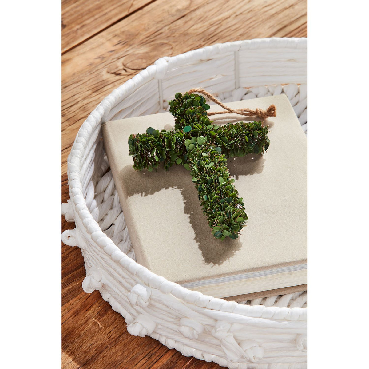 Small plastic boxwood cross measuring seven inches by five and a half inches.