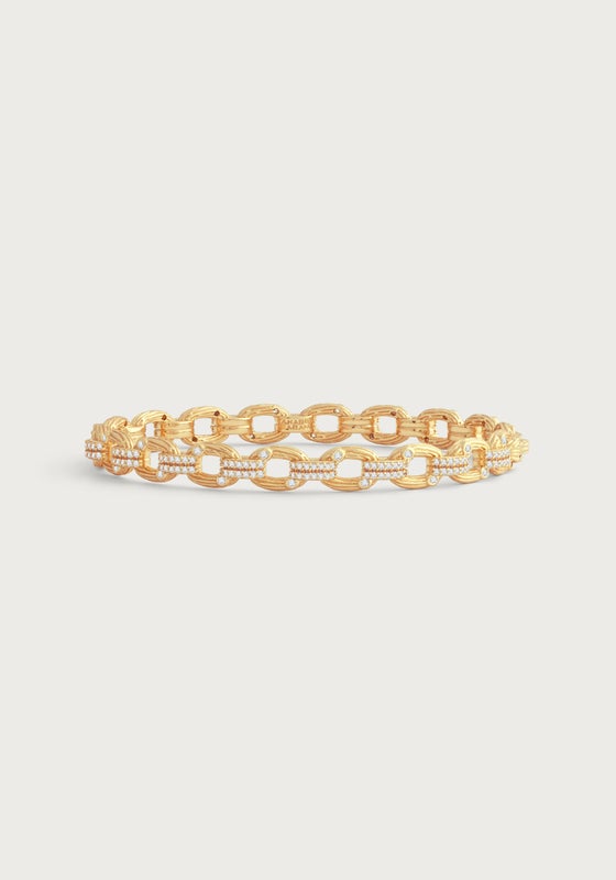 Gold-plated brass hinged bangle with oval twig-textured chain links and shimmering crystal accents.