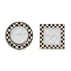 Set of two silver-plated frames with enameled check pattern on a tabletop gallery.