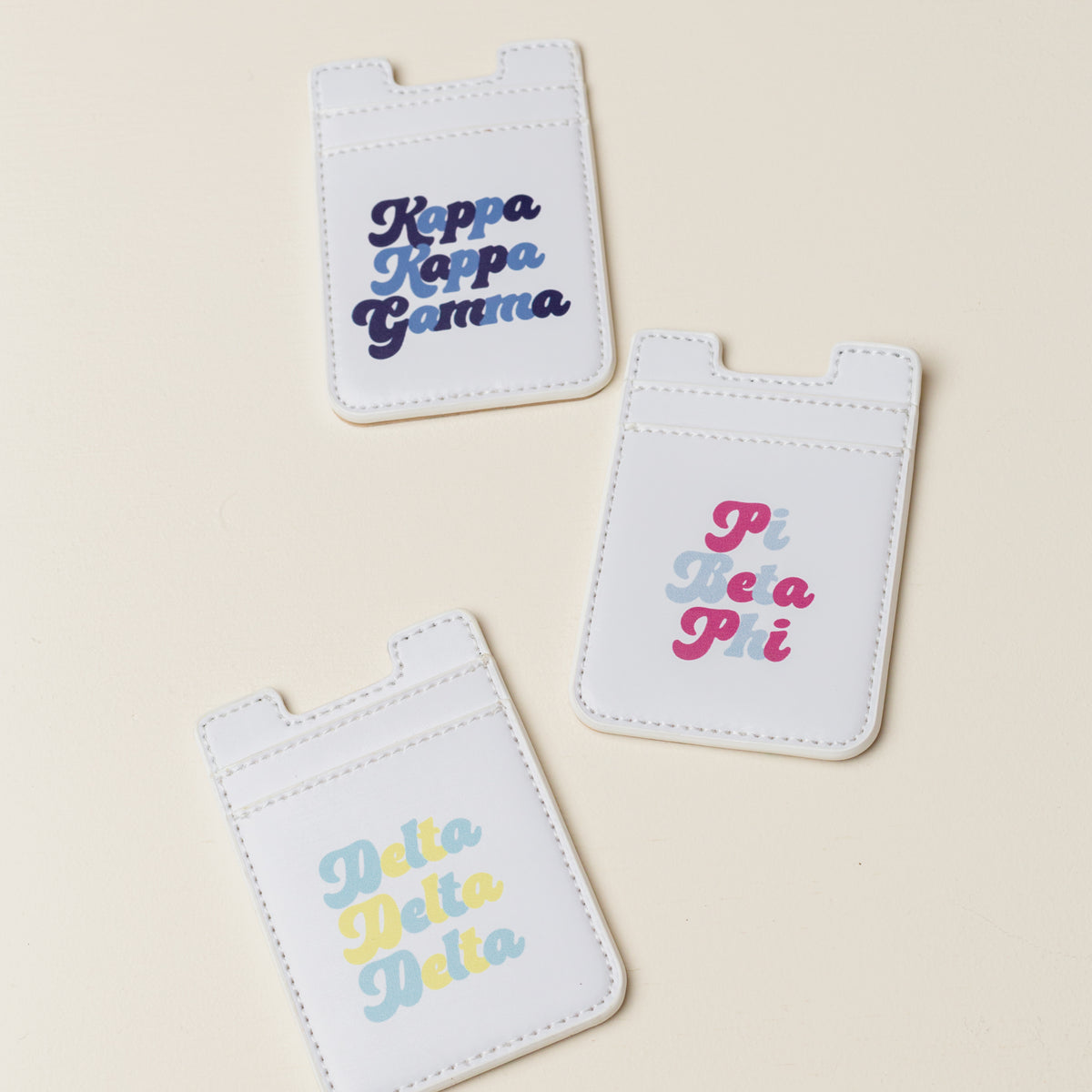 Pink sorority-themed stick-on phone wallet with Greek letter pattern.