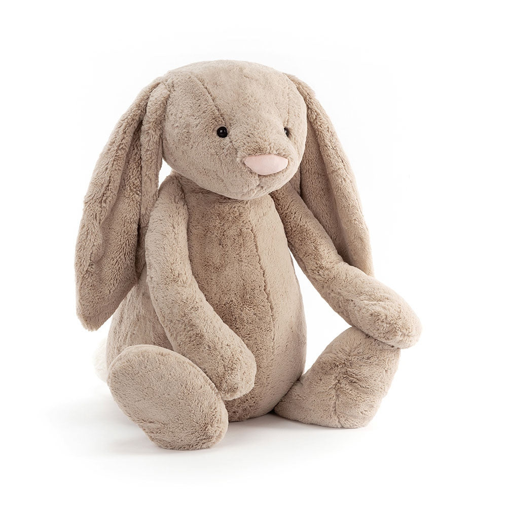 Gigantic Bashful Beige Bunny plush toy with long floppy ears and a pink nose sitting upright.
