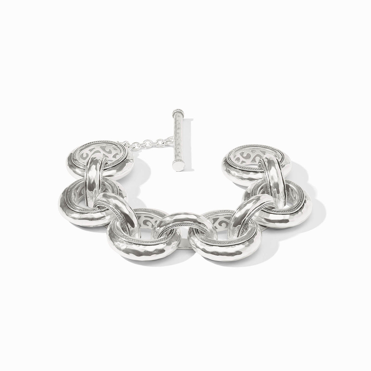 Cannes Link Bracelet in silver with hammered links, pierced interior designs, and a toggle closure.