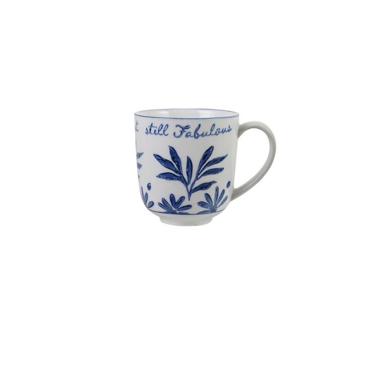 Blue and white stoneware mug with floral designs and the text "still Fabulous".