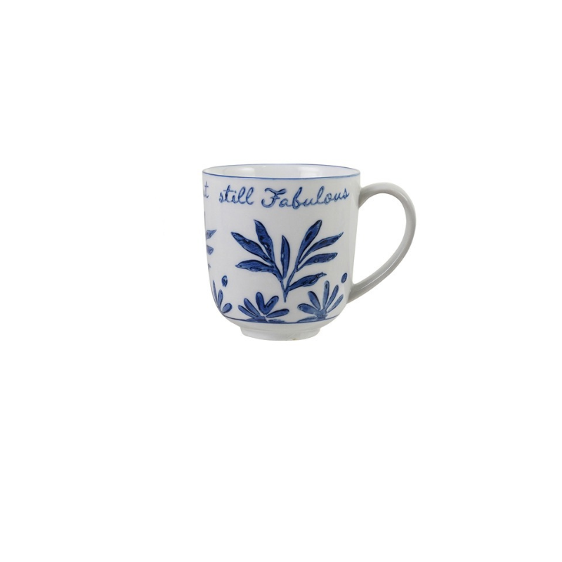 Blue and white stoneware mug with floral designs and the text "still Fabulous".