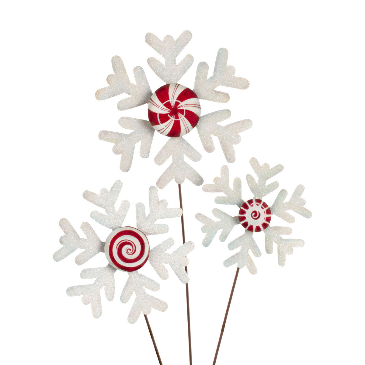 Three white glittery snowflake stakes with red and white peppermint candy centers.