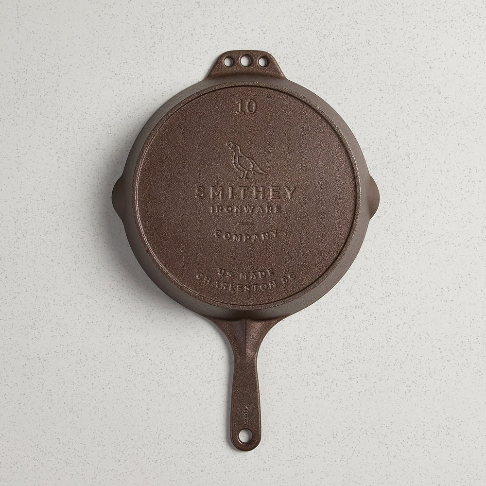 Bottom view of a No. 10 Traditional Skillet showing the Smithey Ironware logo and US Made stamp.