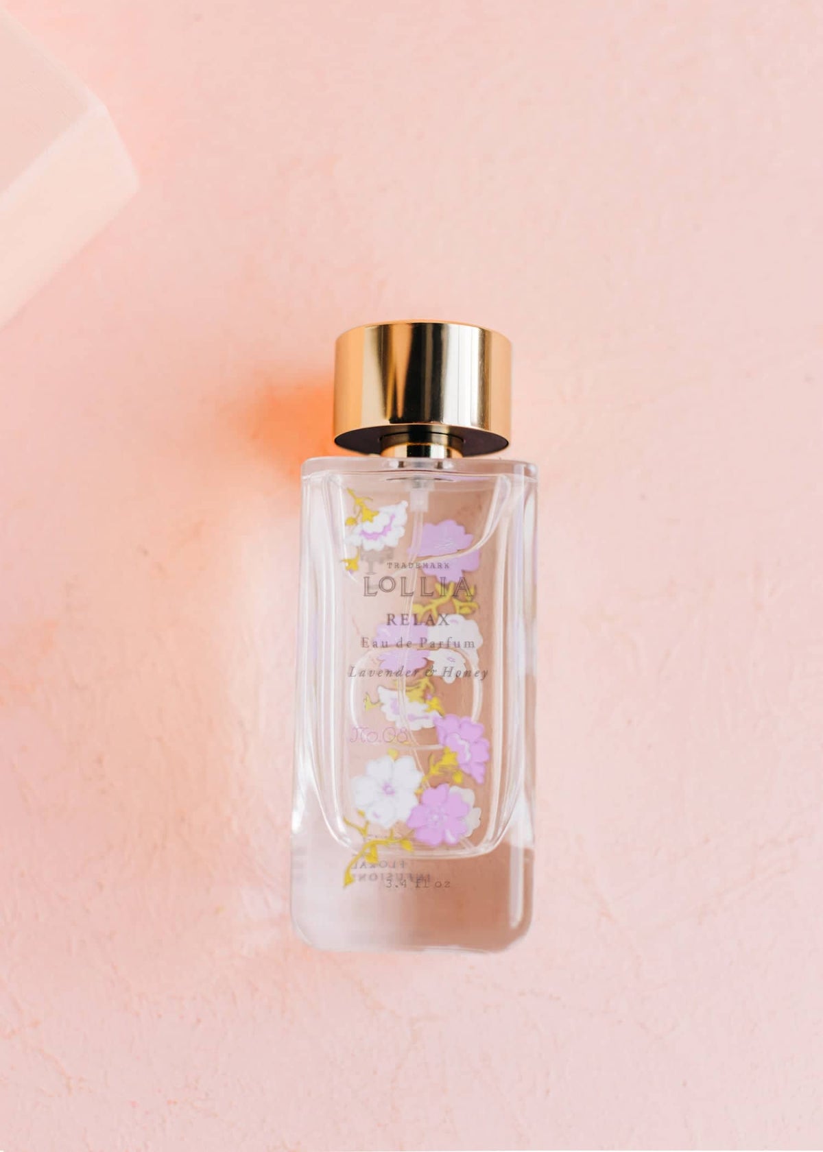 Relax Eau De Parfum in a clear glass bottle with delicate blossom pattern on the label.