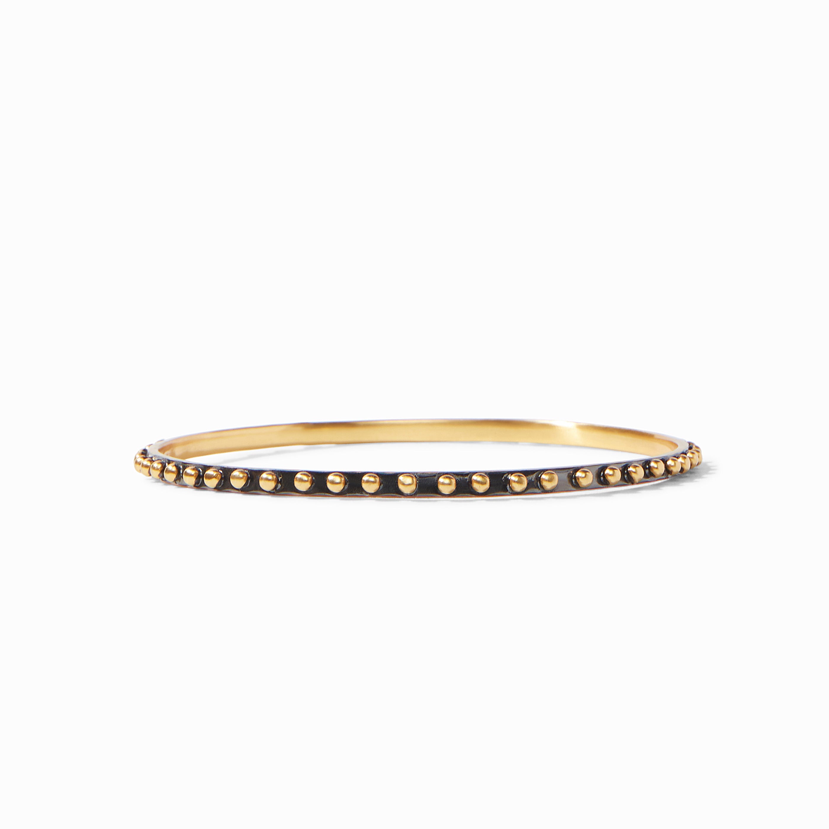 SoHo Bangle featuring a thin gold band with a black outer rim and gold bead accents.