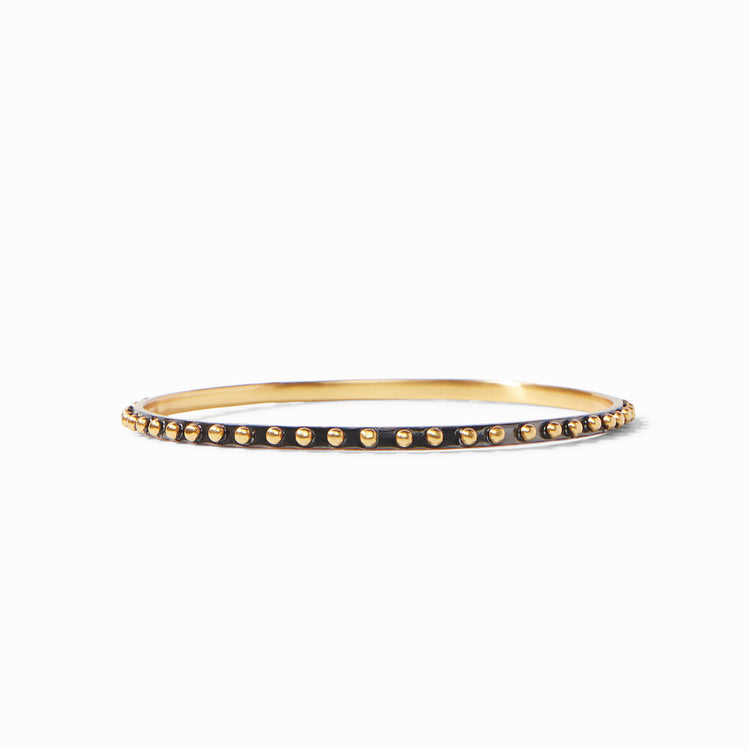 SoHo Bangle featuring a thin gold band with a black outer rim and gold bead accents.