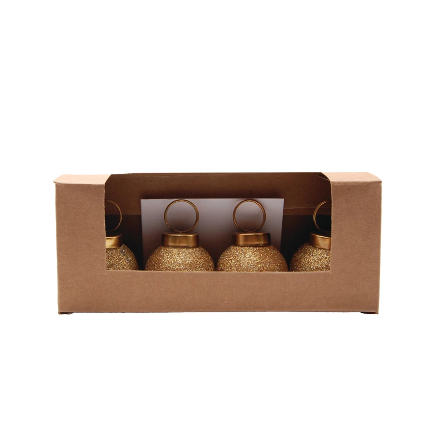 Set of four gold glitter glass ball ornament card and photo holders in a brown cardboard box.