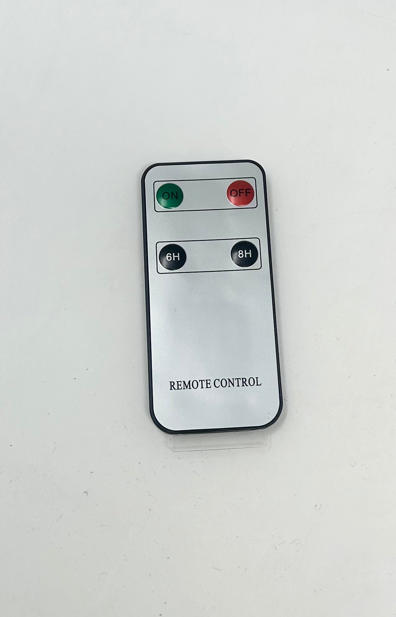 Silver remote control with green ON, red OFF, and black 6H and 8H timer buttons.