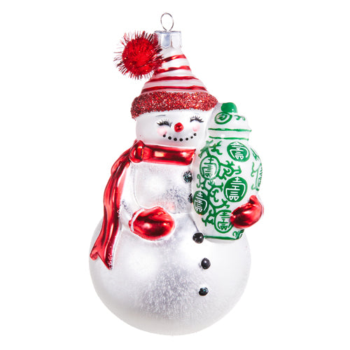 Snowman glass ornament wearing a red scarf and hat, holding a green and white ginger jar.
