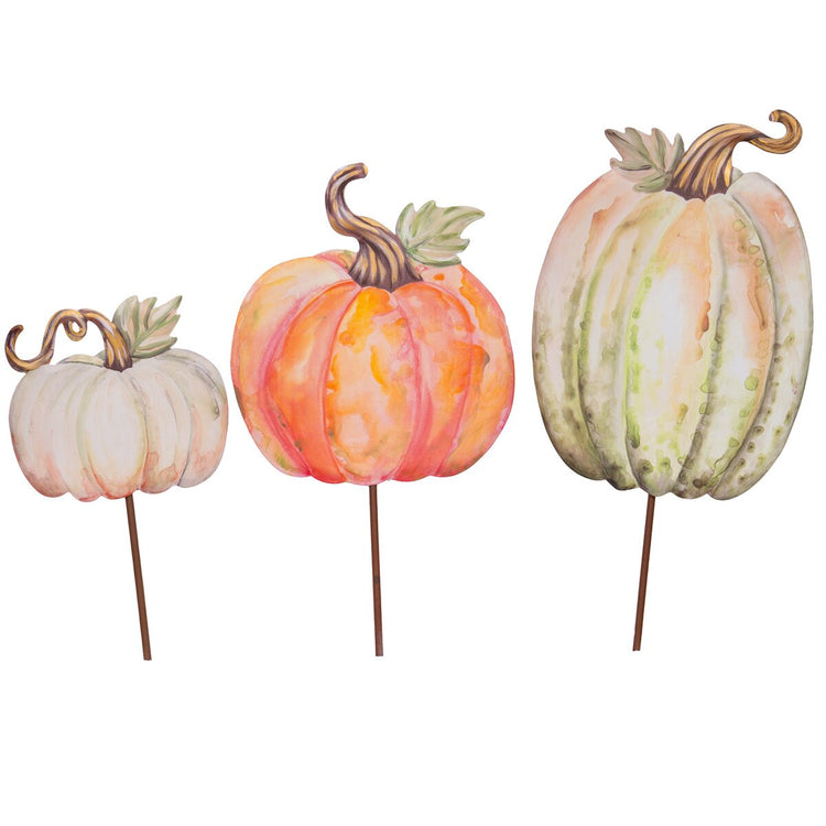 Set of three watercolor-style pumpkin garden stakes in white, orange, and green.