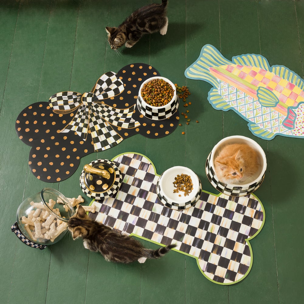 Bone-shaped puppy placemats in black with gold dots and a black-and-white checkered pattern.