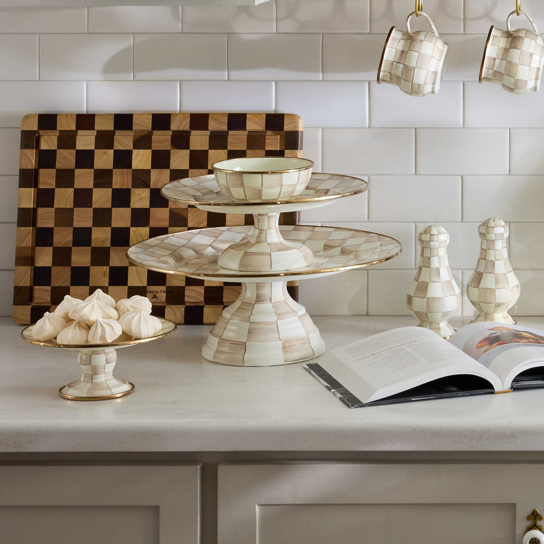 Mocha Check Mini Pedestal Platter holding white meringues on a kitchen counter.