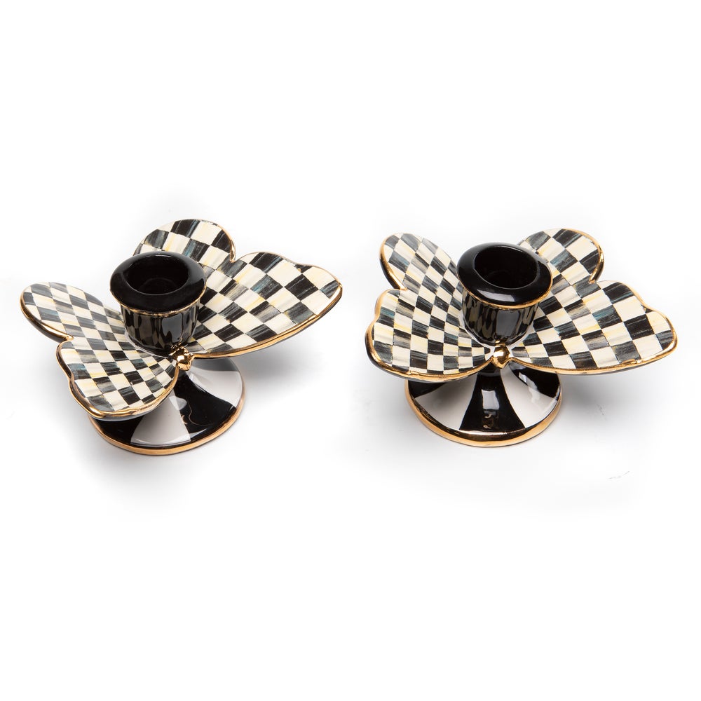 Two ceramic candle holders with gold lustre accents featuring a courtly check pattern.