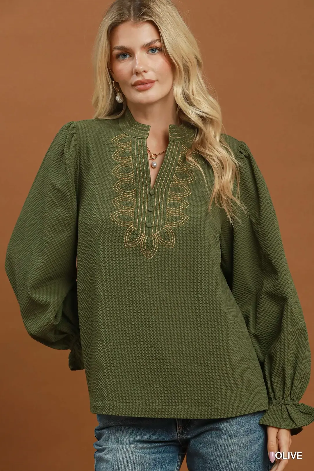 Olive green textured blouse with gold neck stitch embroidery and long puff sleeves.