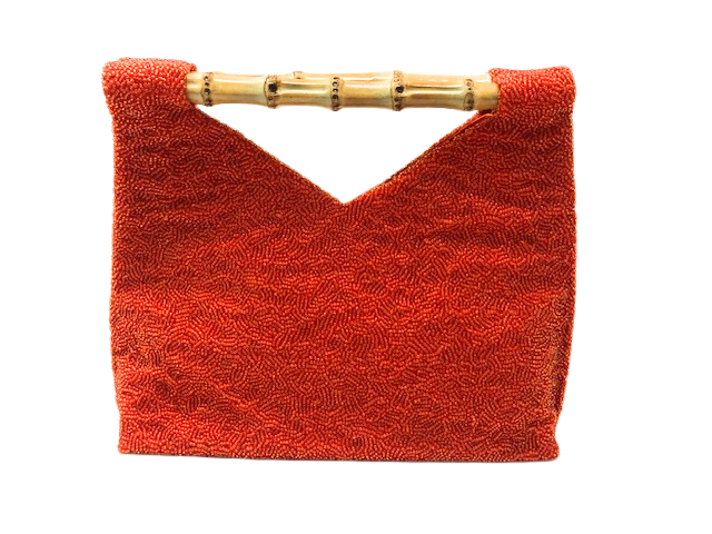 Orange beaded clutch bag with a bamboo handle and a V-shaped top opening.