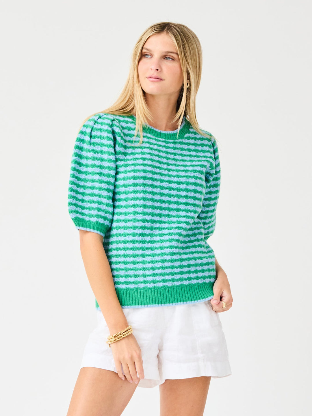 Woman wearing the Abigail Sweater, a green and blue striped short-sleeve knit with puff sleeves.