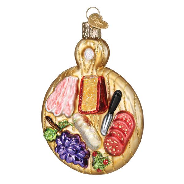 Glass charcuterie board ornament featuring cheese, meats, grapes, and a knife with glitter accents.