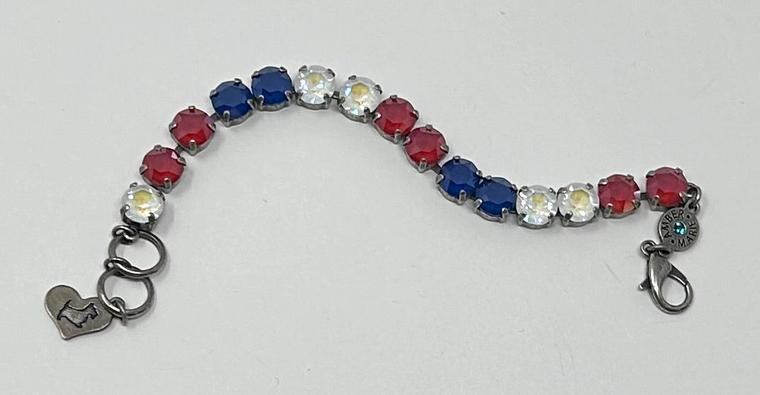 Red, white, and blue crystal bracelet with a heart-shaped charm and lobster clasp closure.