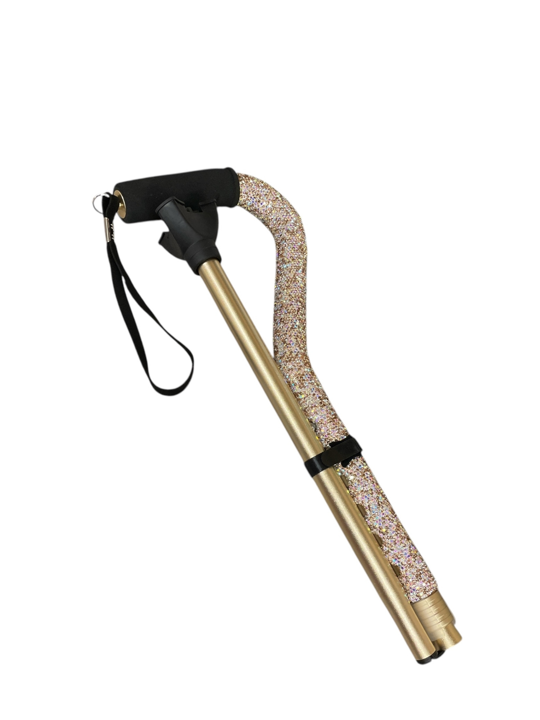 Folded gold walking cane with a sparkling rhinestone-covered shaft and black foam handle.