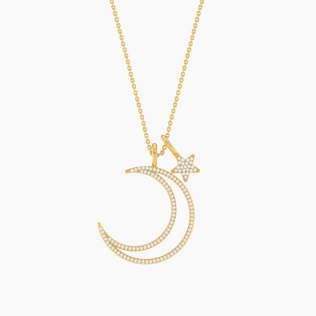 Gold crescent moon and star pendant necklace with diamond accents on a delicate chain.
