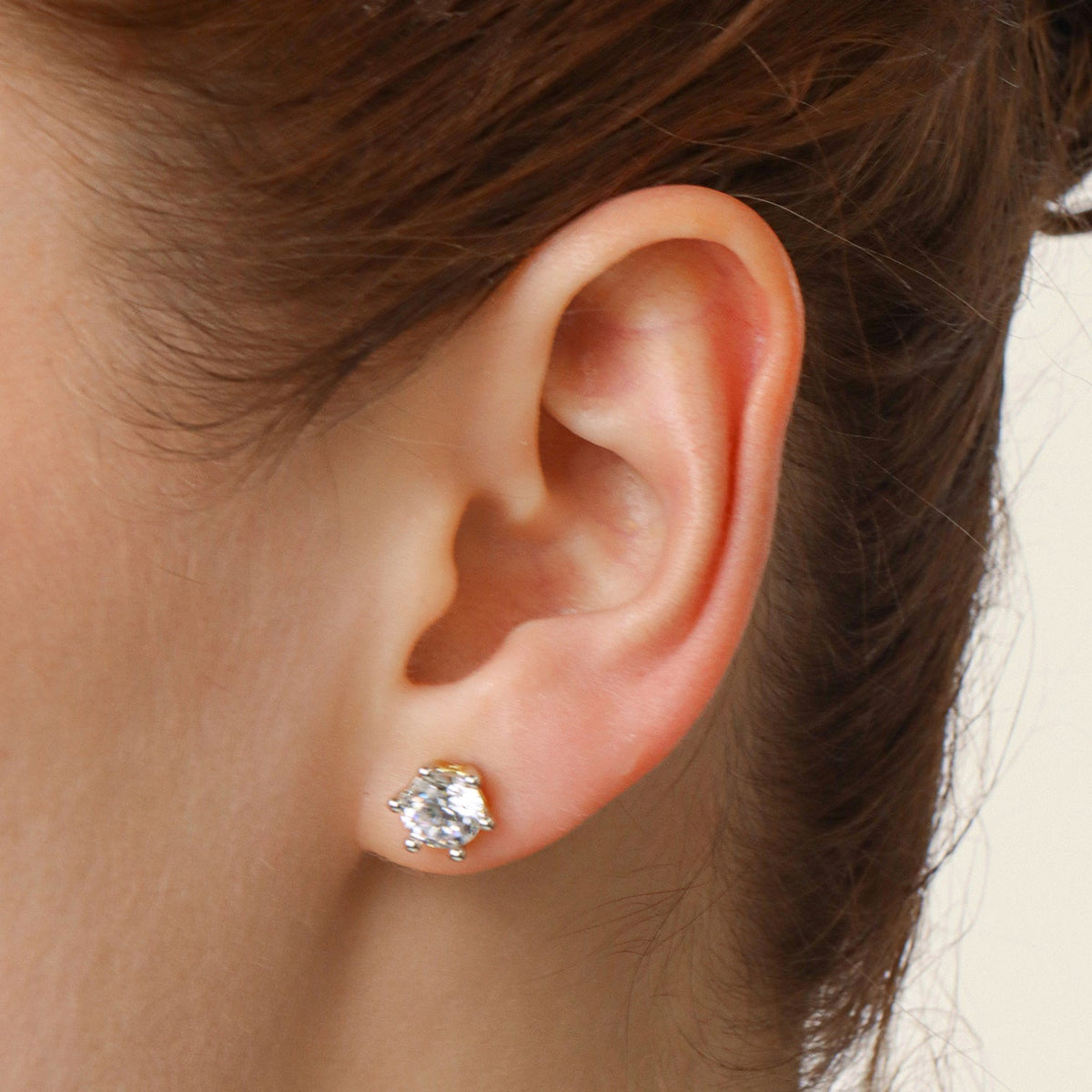 Lab-grown diamond stud earrings in gold with a six-prong setting.