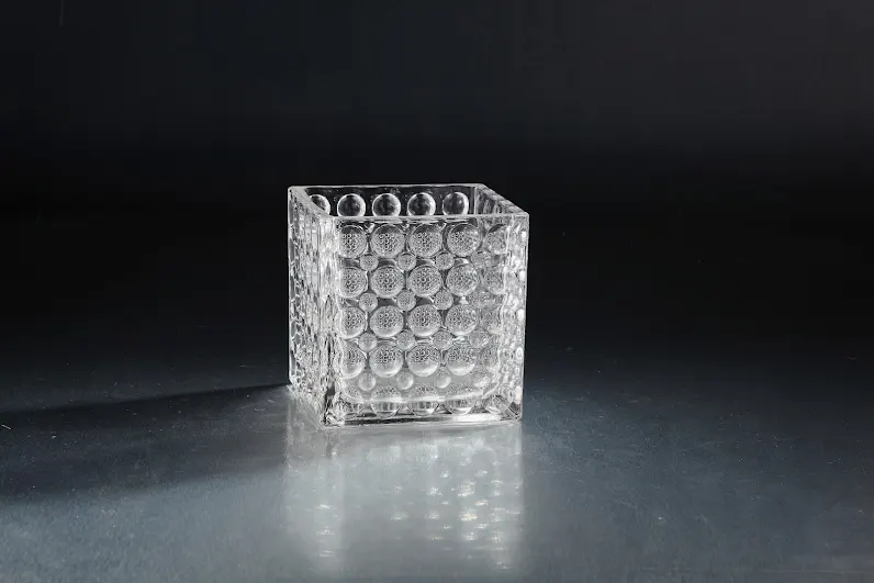 6-inch square clear glass vase with a textured bubble pattern on a dark reflective surface.