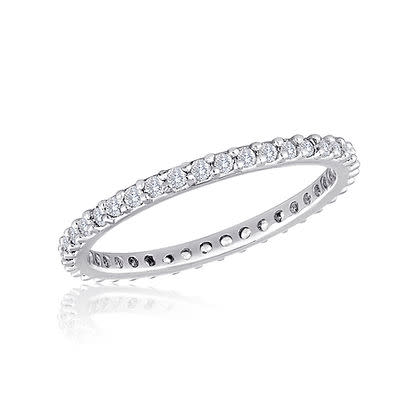 Thin diamond stack ring featuring a delicate band with small round-cut stones in silver-tone metal.