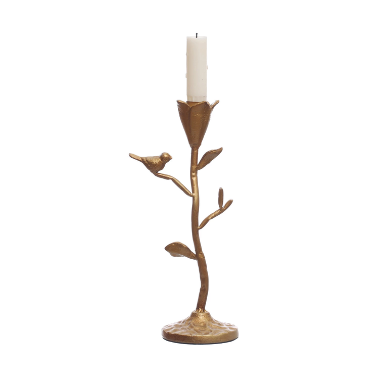 Hand-forged gold metal candle holder shaped like a branch with a bird and a white taper candle.