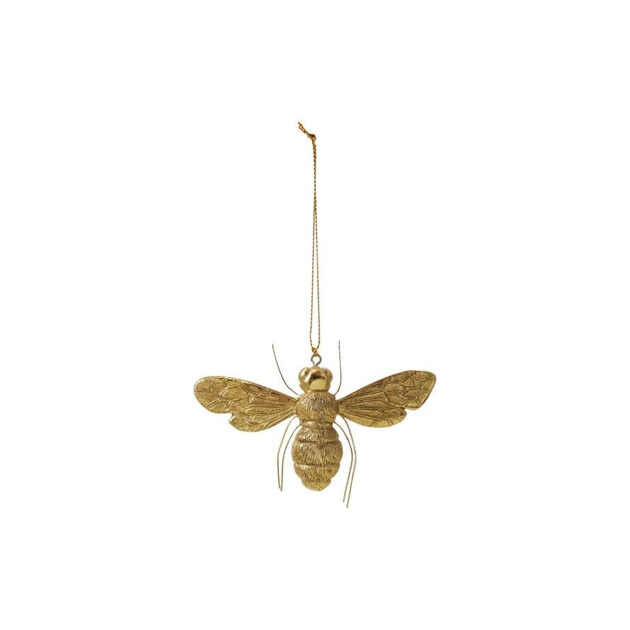 Gold finish resin bee ornament with wire legs and a hanging string.