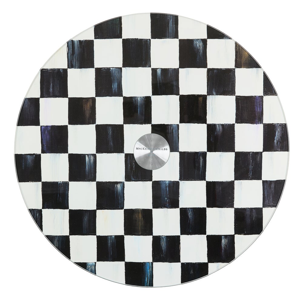 Round tempered glass lazy susan with a hand-painted black and white checkered pattern.