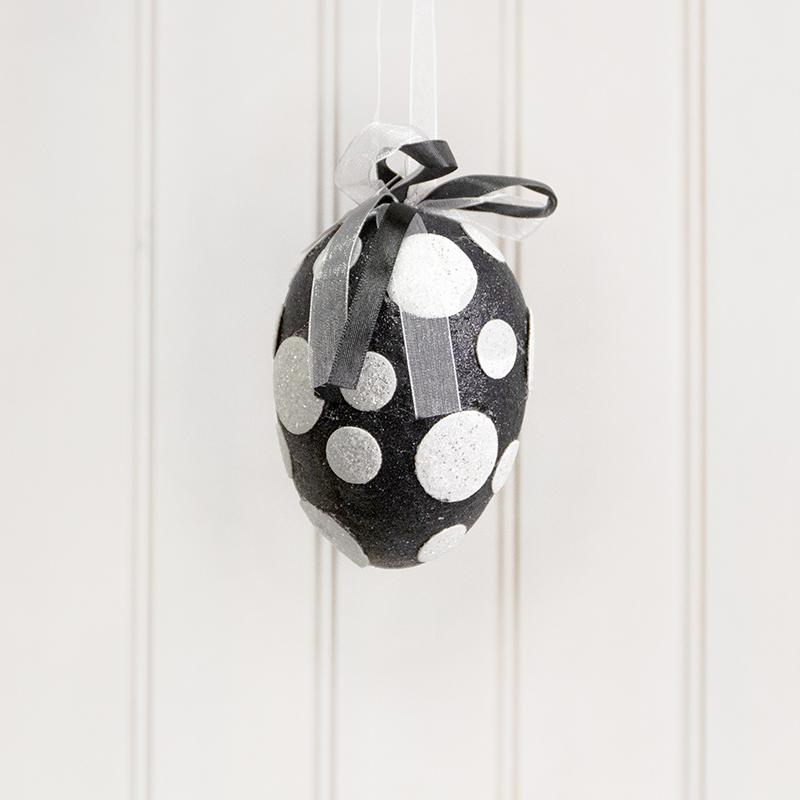 Black foam egg ornament with white polka dot glitter pattern