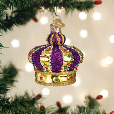Purple and gold glass Crown Of Royalty Ornament with colorful glitter accents on a Christmas tree.