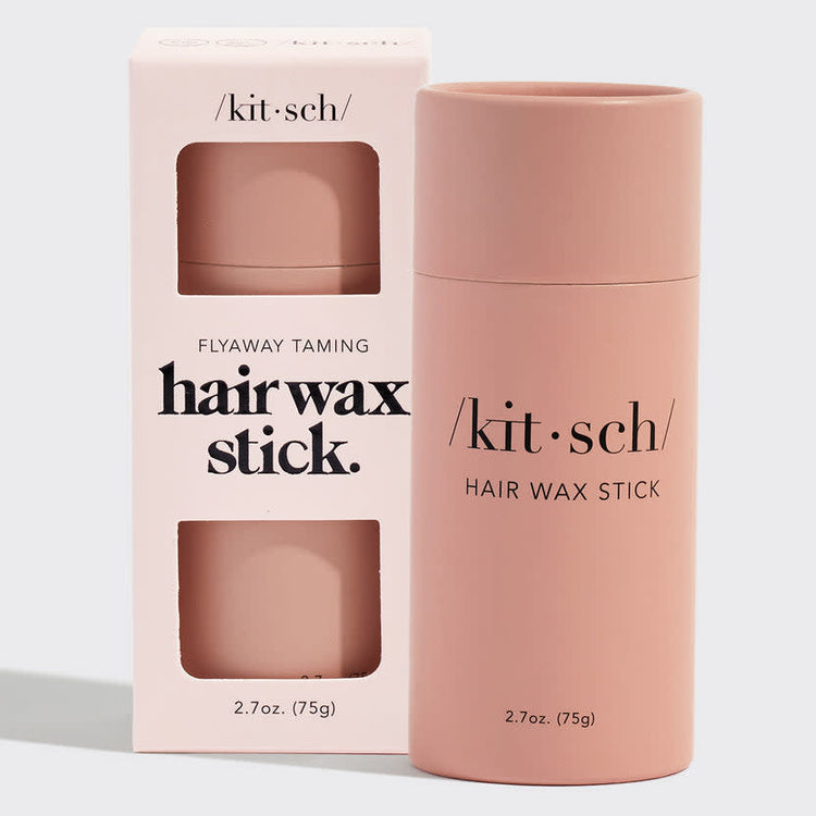 Solid hair wax stick in a biodegradable paper tube with natural brown color.