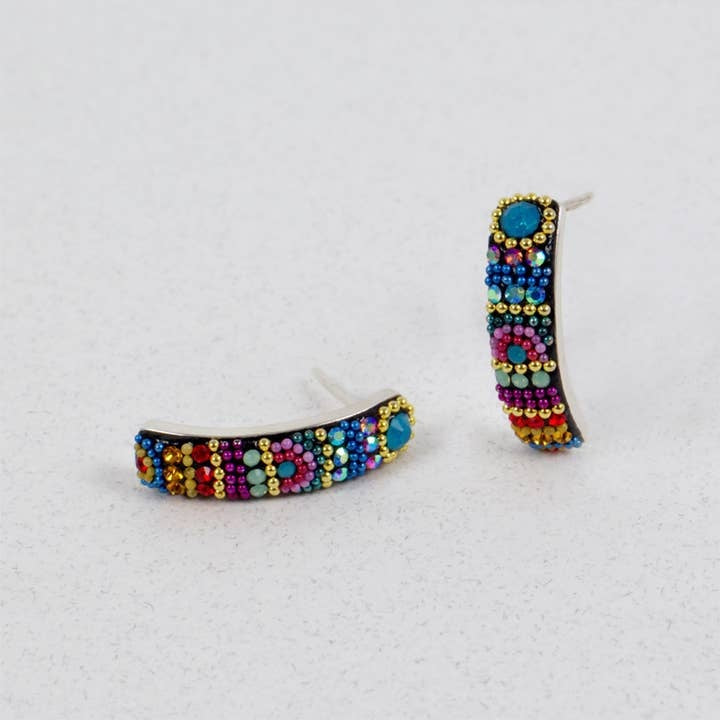 Sterling silver half hoop earrings featuring Austrian crystals in a sparkling pattern.